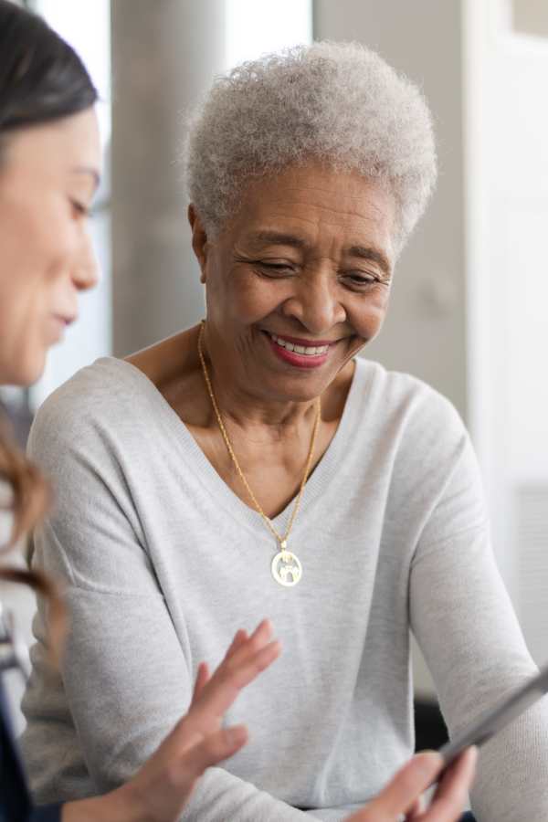 Employee helping a resident on the phone at Merrill Gardens at Rockridge in Oakland, California
