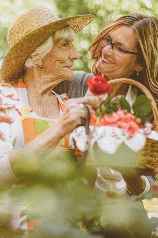 Resident with a basket of flowers at Merrill Gardens at Burien in Burien, Washington